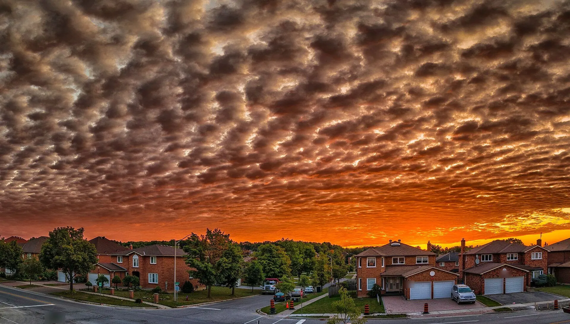 Brick family homes under a blazing sunset sky in Richmond Hill