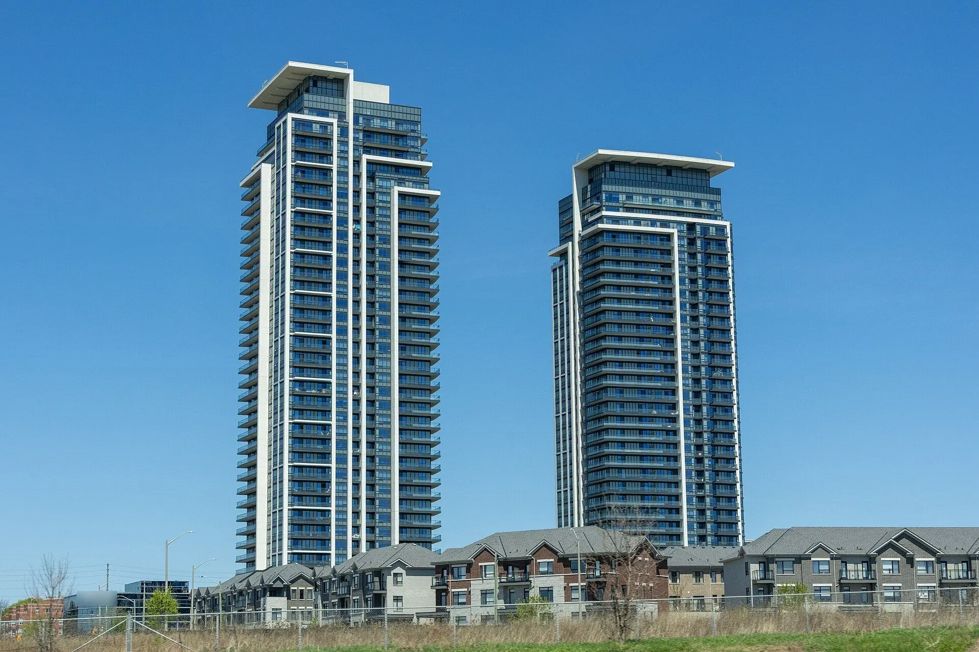 Twin condominium towers above new townhomes in Markham